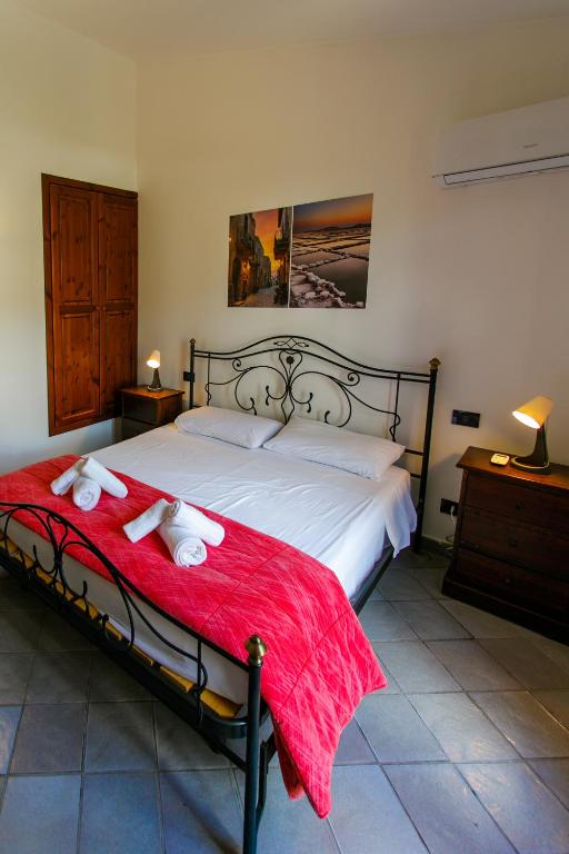a bedroom with a bed with two towels on it at SanVitoTour- Residence Il Baglio in San Vito lo Capo