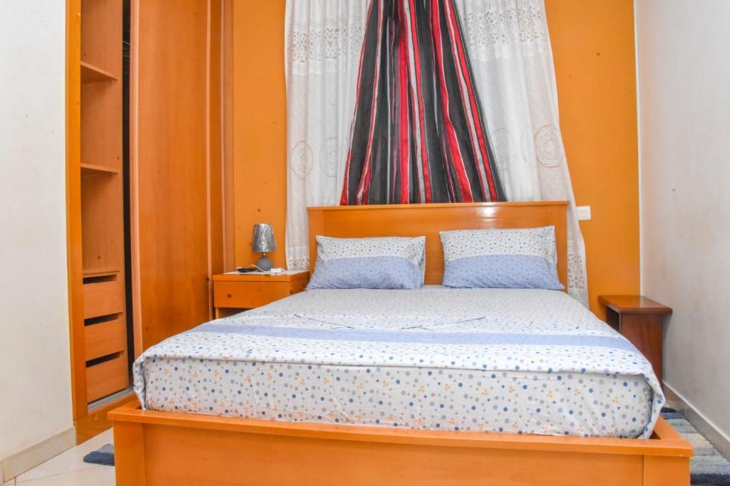 a bedroom with a wooden bed with two pillows at Hot belvedere in Praia