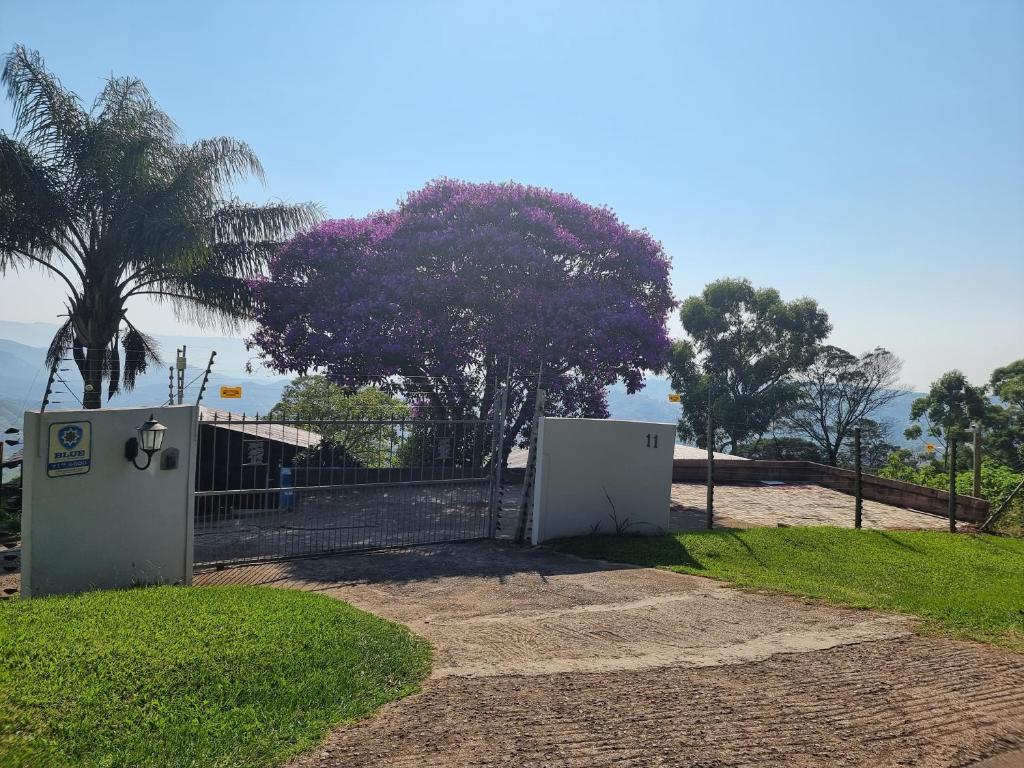 a gate to a house with a fence and trees at 11-on-RobRoy serenity glamping cabins overlooking the Valley of 1000 Hills in Hillcrest