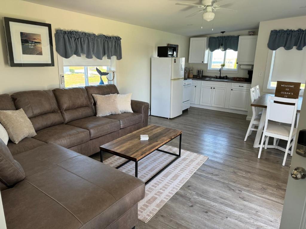 a living room with a couch and a table and a kitchen at Quaint, family friendly Beach house for 4 in South Dartmouth