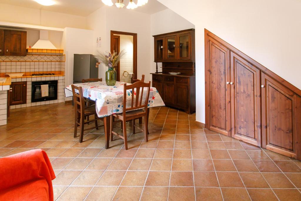 a kitchen and dining room with a table and chairs at SanVitoTour- Residence Il Baglio in San Vito lo Capo