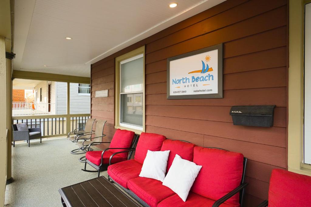 a red couch sitting on the side of a building at North Beach Hotel in Ventnor City