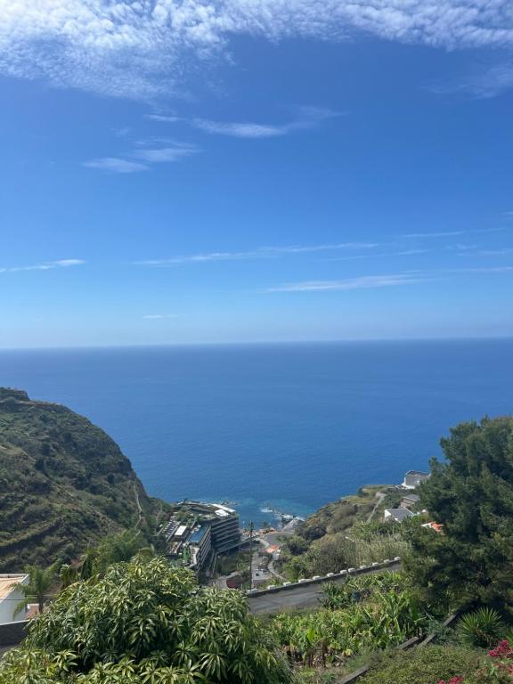 a view of the ocean from a hill with a road at Pana House in Calheta