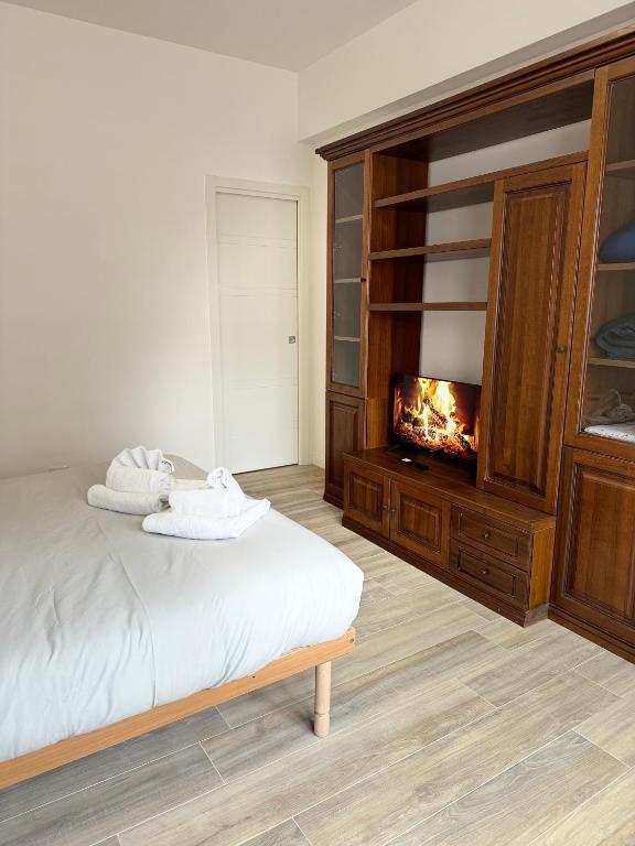 a bedroom with a bed and a fireplace at Cerreto Suite Housing in Rome