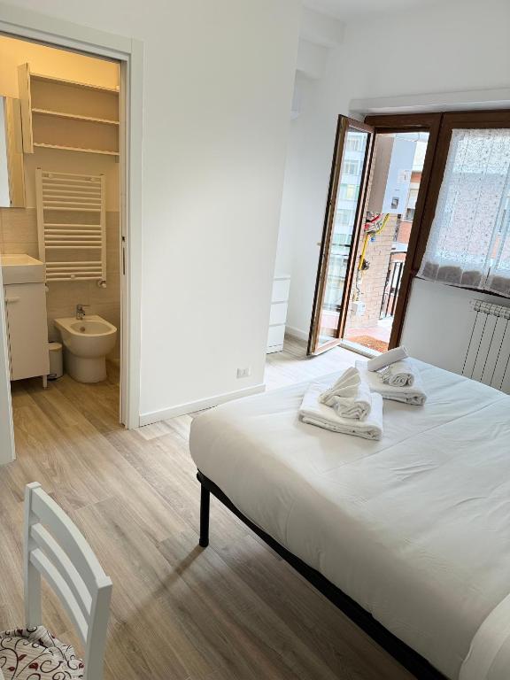 a bedroom with a bed and a bathroom with a window at Cerreto Suite Housing in Rome
