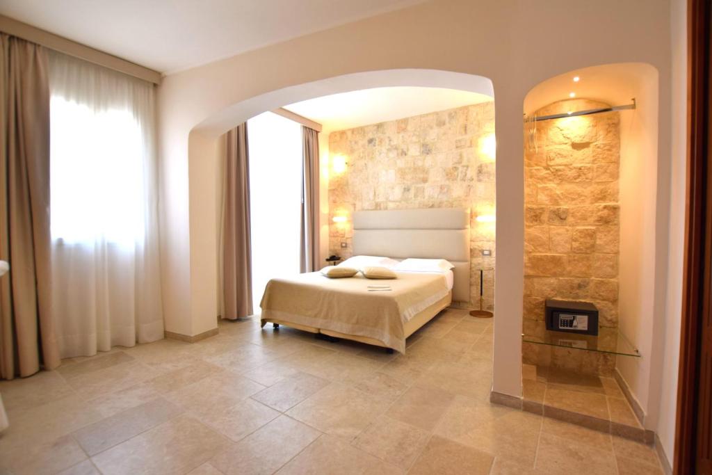 Postel nebo postele na pokoji v ubytování Hotel L'Arcangelo - Boutique Hotel