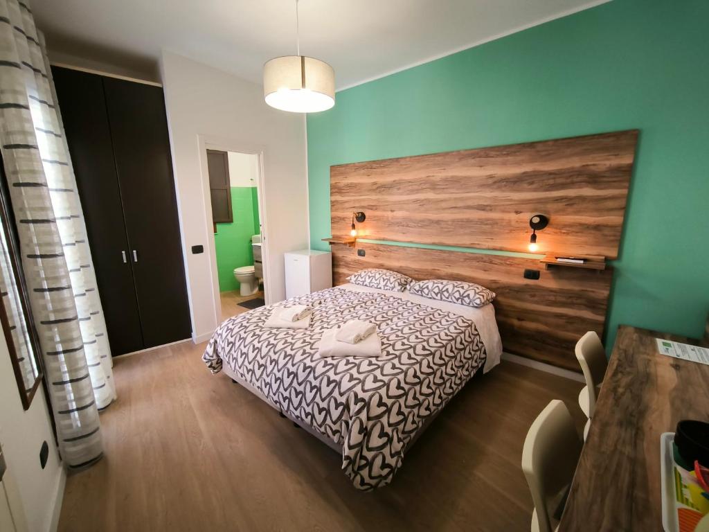 a bedroom with a bed with a wooden headboard at Santa Lucia in Caltanissetta