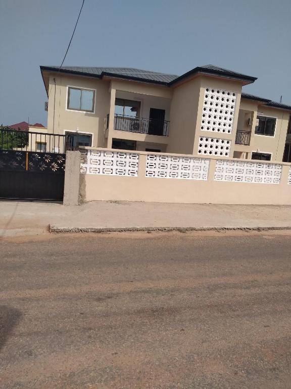 a white fence in front of a house at Atvam properties in Adisadel