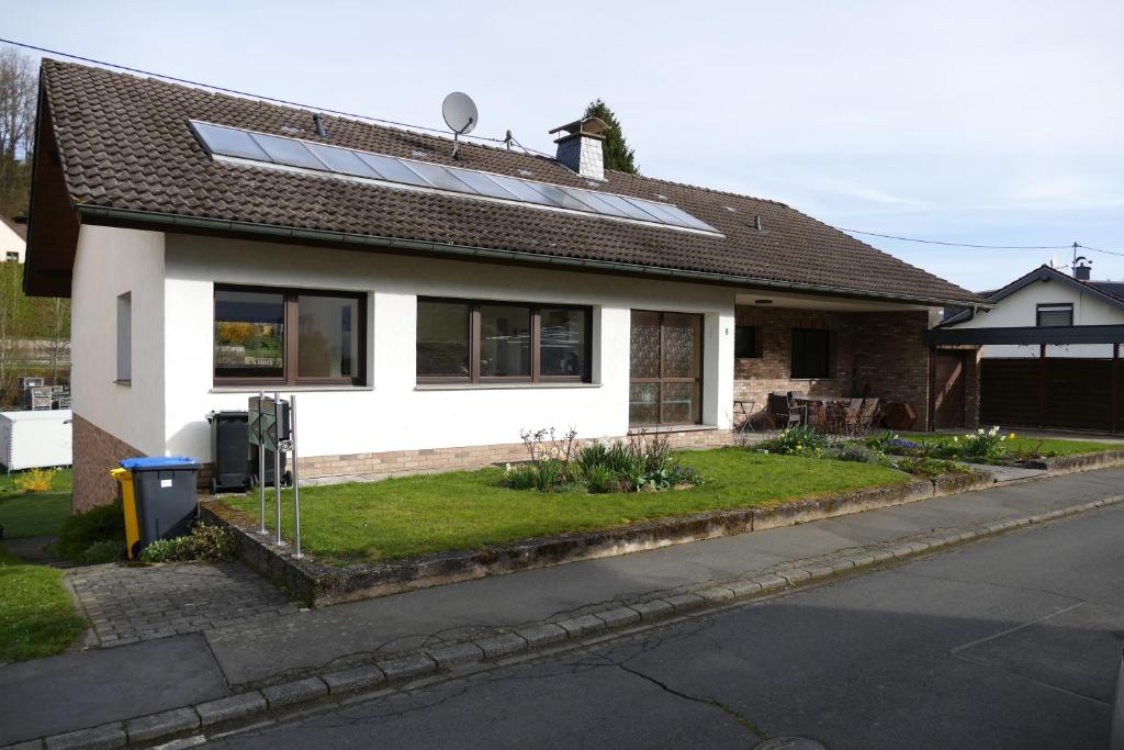 a house with solar panels on the roof at Ferienwohnung Hilberath in Wimbach