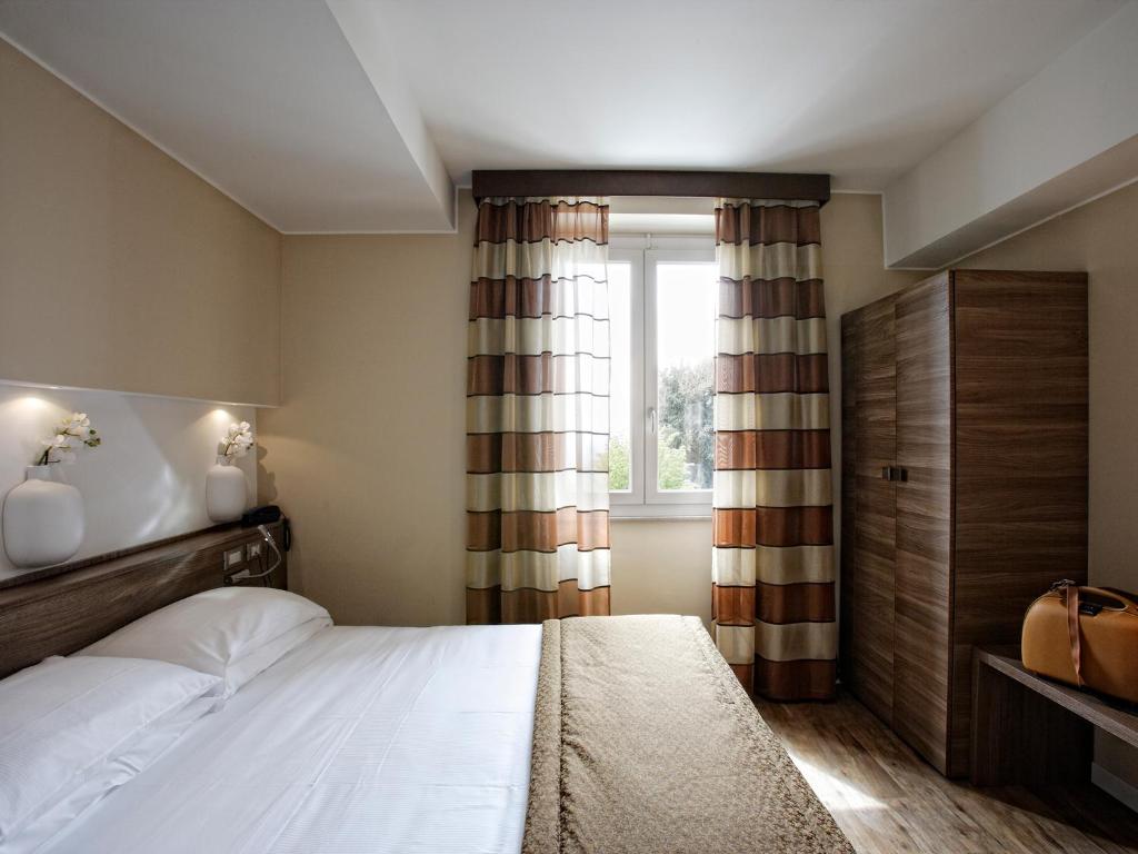 Postel nebo postele na pokoji v ubytování Hotel Porta Nuova