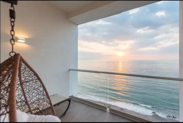 a room with a view of the ocean from a balcony at Harbor 171 in Puerto Vallarta