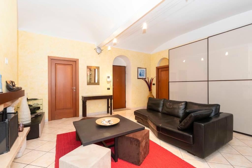 a living room with a couch and a table at Sweet Apartment nel cuore di Torino in Turin