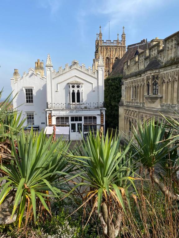 a large white building in front of a castle at The Cafe Apartment in Great Malvern
