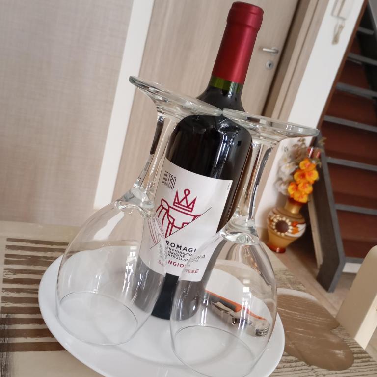 una bottiglia di vino appoggiata su un piatto di Casa Nicotera a Noto