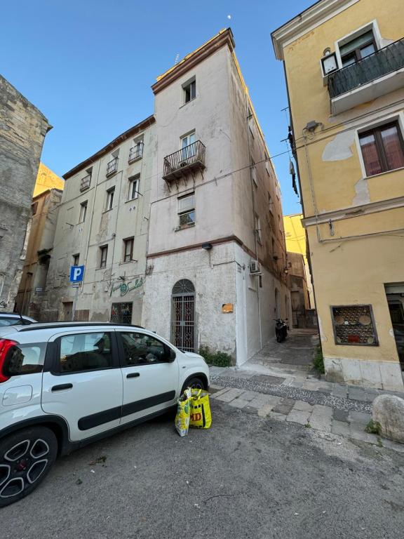 a white car parked in front of a building at Civico 10 II in Sassari