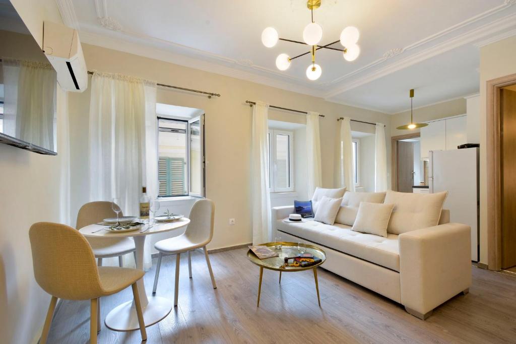 a living room with a white couch and a table at Island Suite, Old Town in Corfu