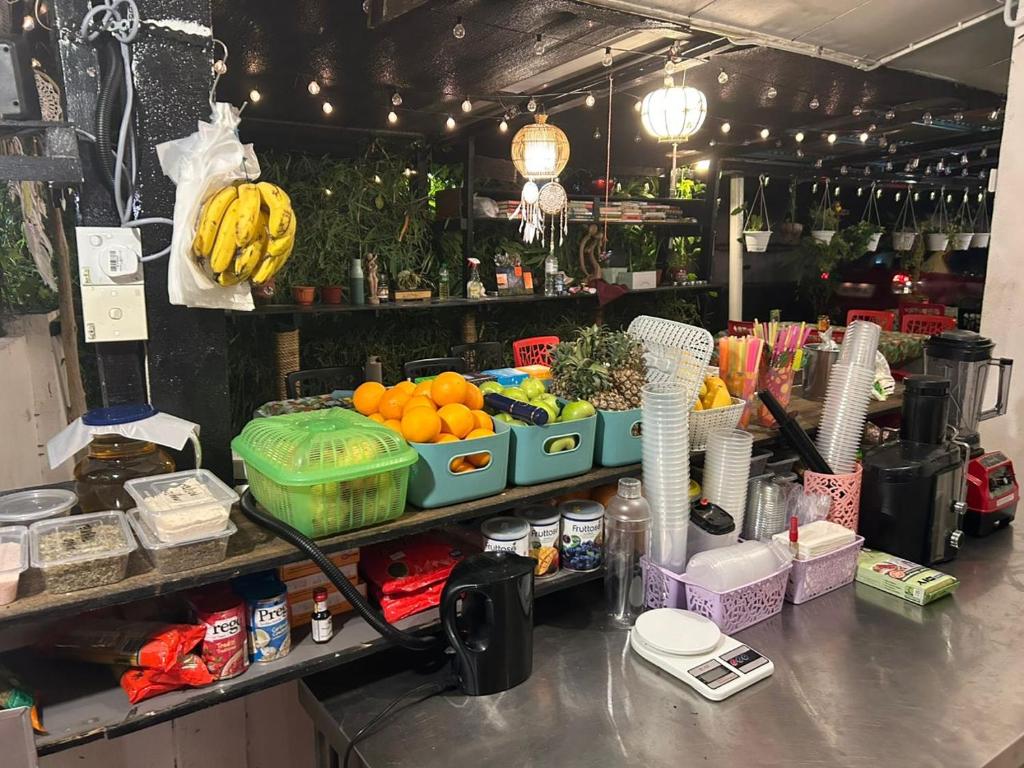 a counter with a bunch of fruits and vegetables at MIMPIMOON Bunk Beds & Home in Pantai Cenang