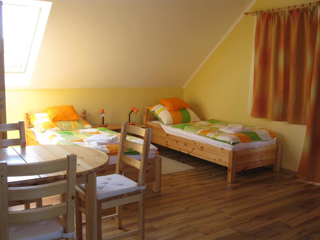 Postel nebo postele na pokoji v ubytování VIDOR Vendégház