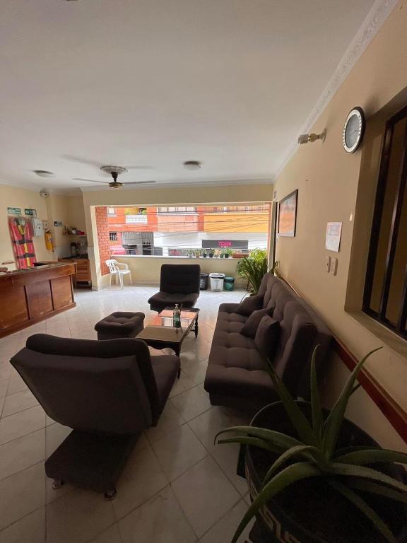 Puerto Berrío的住宿－Aparta Hotel Nutibara，客厅配有沙发和桌子