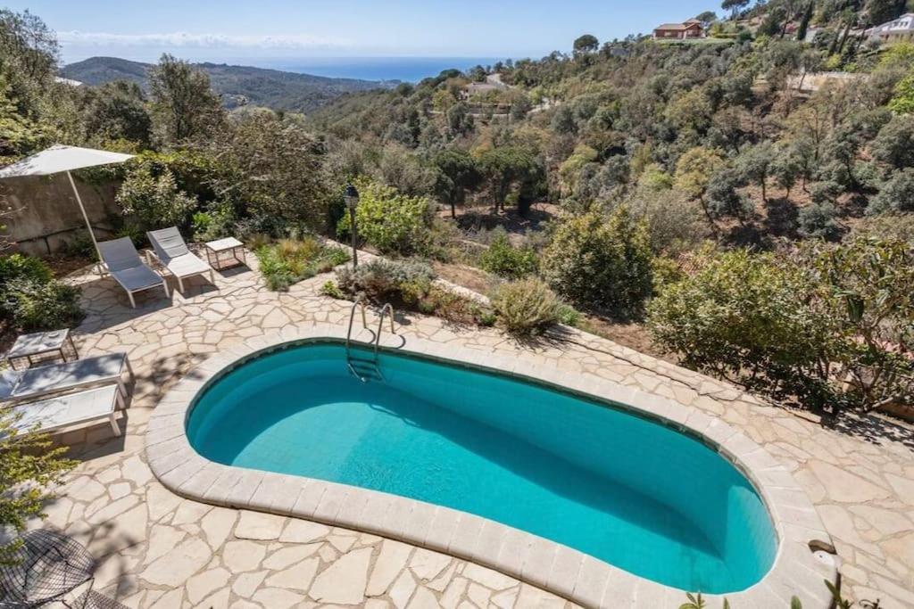 a swimming pool with a view of the ocean at ThePineRooms in Arenys de Munt