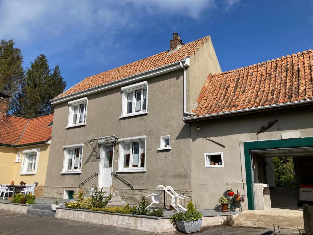 a gray house with a red roof at La Source de la Liane in Menneville