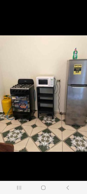 a kitchen with a stove and a refrigerator at Casa de mar in La Libertad