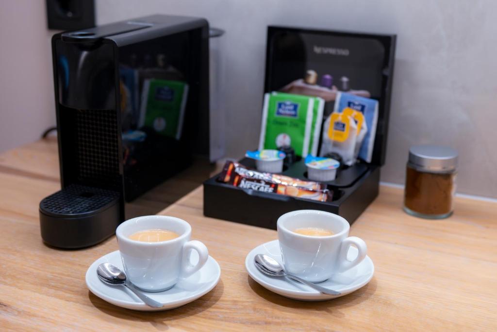 two cups of coffee sitting on top of a table at Nissos Apartments in Myrina