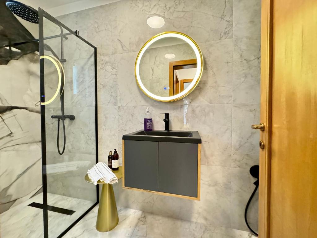 a bathroom with a shower and a sink and a mirror at Elite Plus Cornisa in Târgu-Mureş
