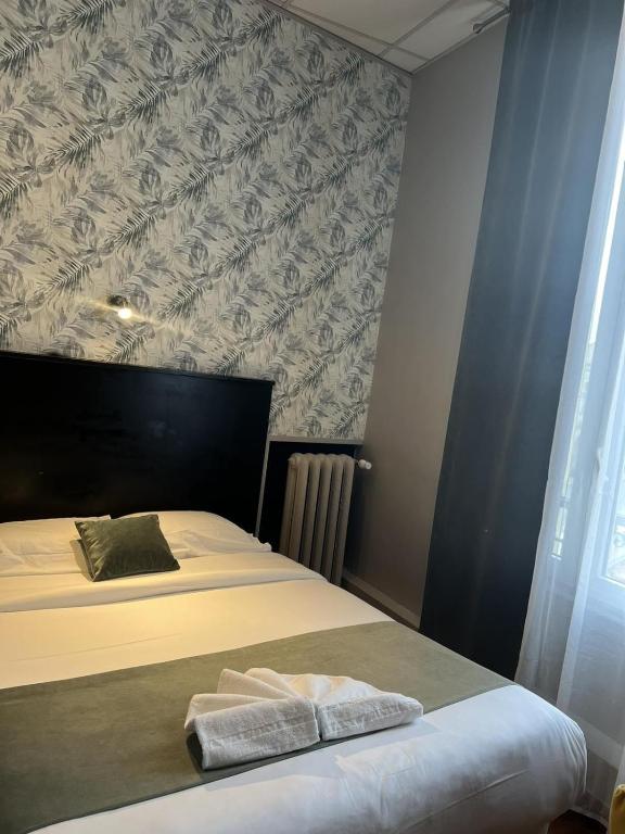 Postel nebo postele na pokoji v ubytování Hôtel Abalone - Centre Gare