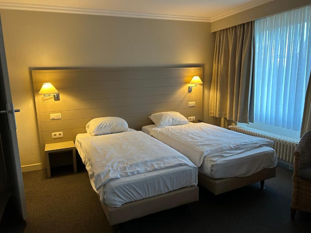 Postel nebo postele na pokoji v ubytování Hotel Atlas