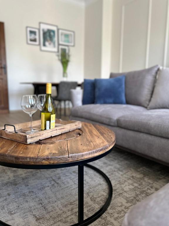 a table with a bottle of wine and a glass at Apartament No. 5 City Center in Świdnica