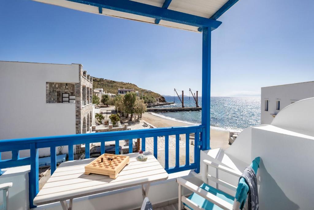 a balcony with a table and a view of the water at Bella Vista Mare in Moutsouna Naxos