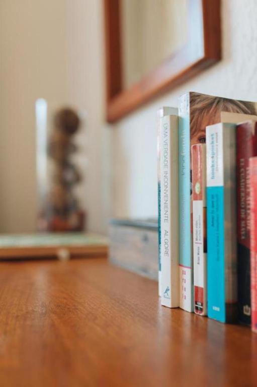 a row of books sitting on a table at VOCÊ HOTEL Punta del Este in Punta del Este