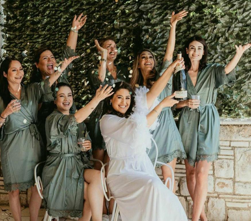 a group of women in green dresses holding champagne bottles at Dalmatian House, spacious stone terraces, balcony , views in Dubrovnik