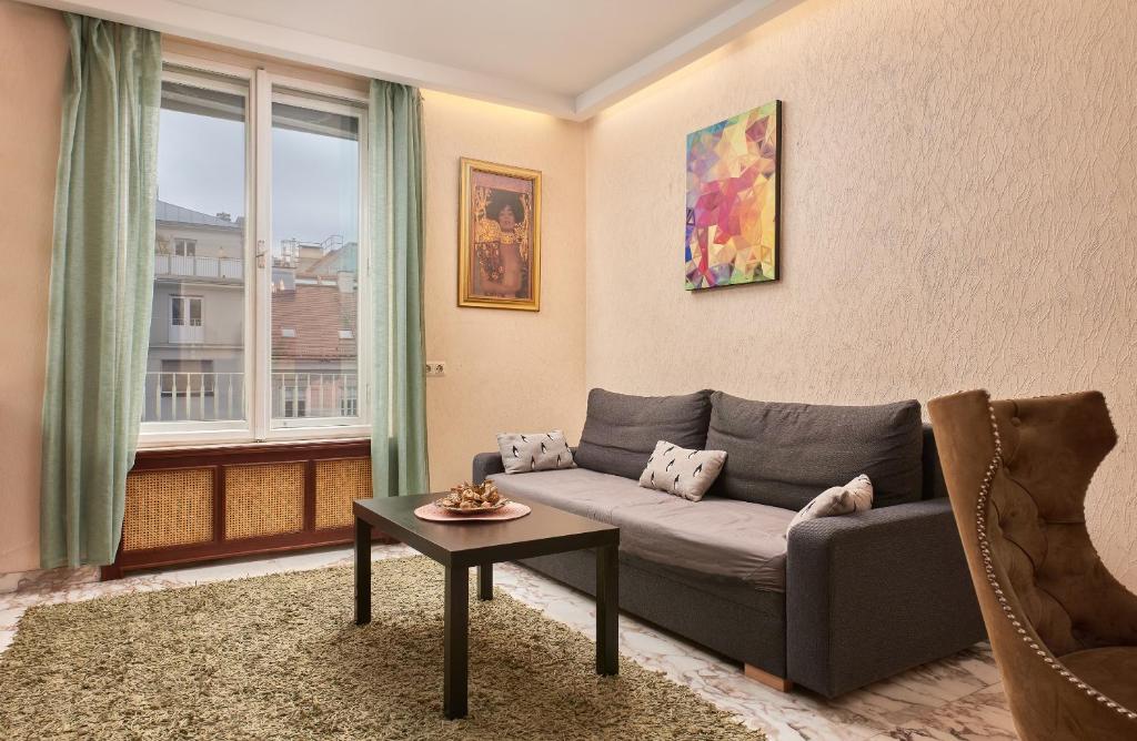 a living room with a couch and a table at Exclusive Central Spacious Apartment in Innere Stadt w Free Parking in Vienna