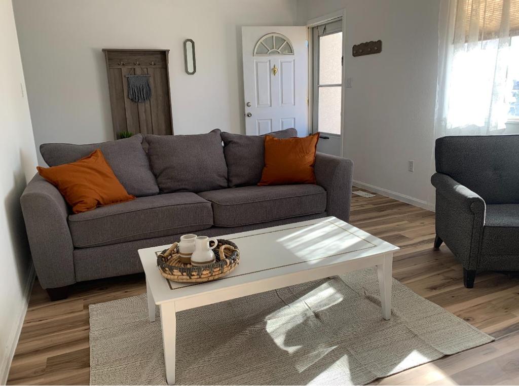 a living room with a couch and a coffee table at Lovely 2- Bedroom Duplex in Pueblo West in Pueblo West