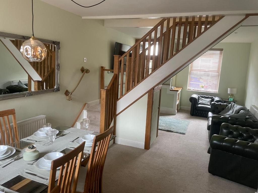 a dining room with a table and a stairway at Impeccable 3-Bed House in York in York