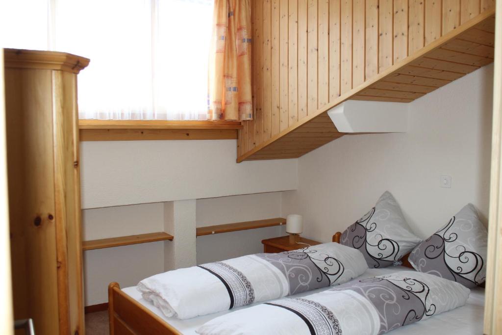 Postel nebo postele na pokoji v ubytování Ferienwohnungen Walserhof Malbun