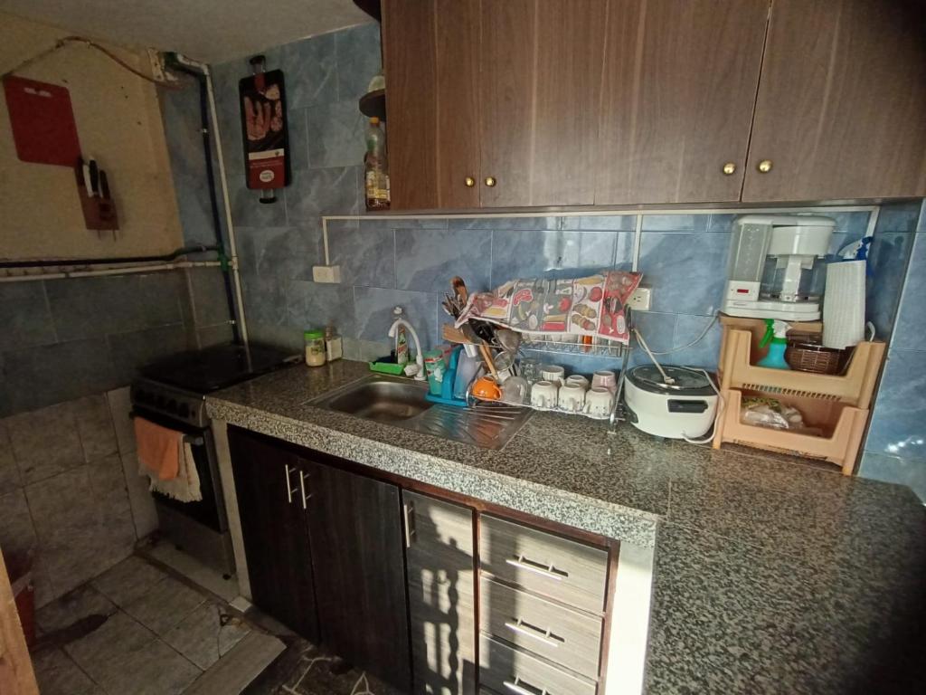 a kitchen with a sink and a counter top at MI CASITA VERDE in Baños