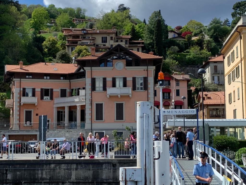 a group of people on a bridge over a river at VECCHIA STAZIONE in Menaggio