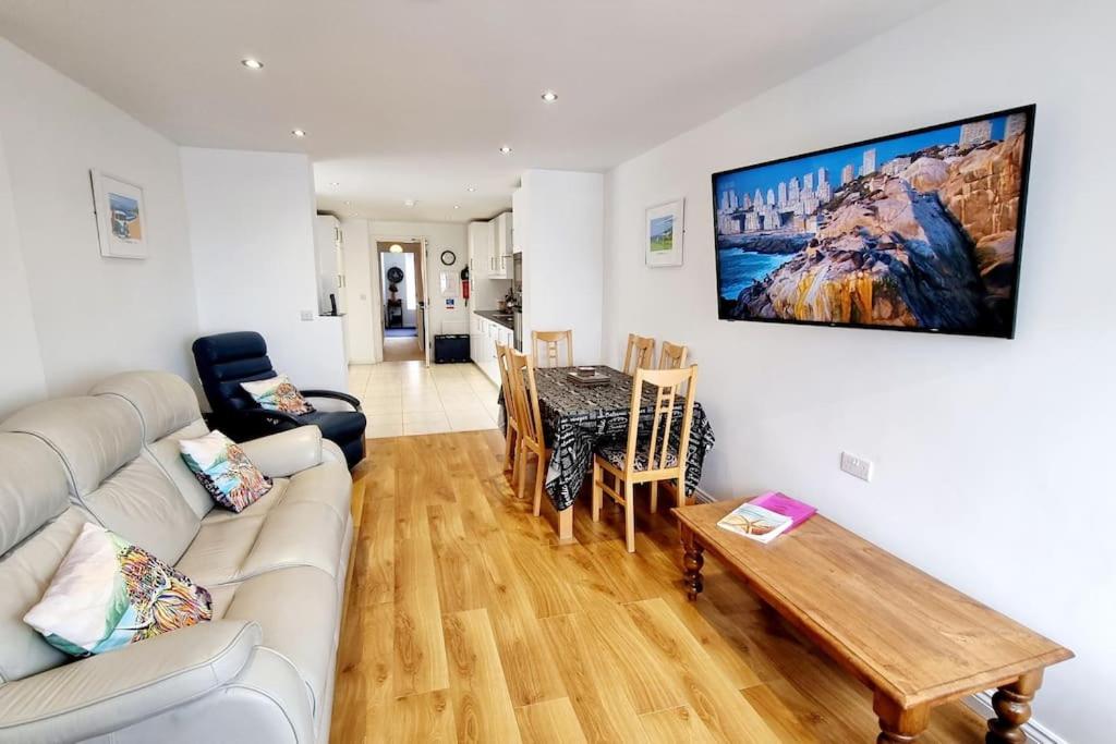 a living room with a couch and a table at Causeway97 Townhouse in Portrush