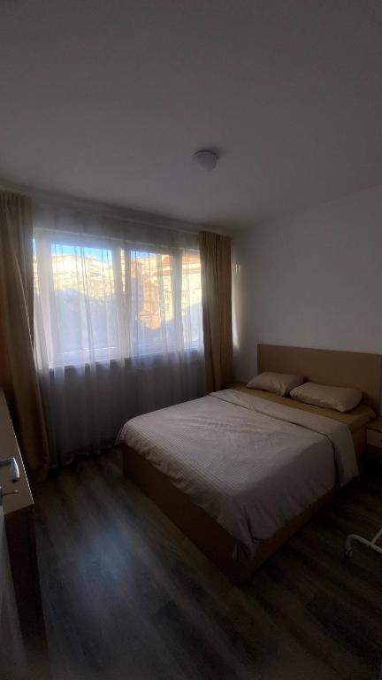 a bedroom with two beds and a window at Private Room in city centre KM0 in Bucharest