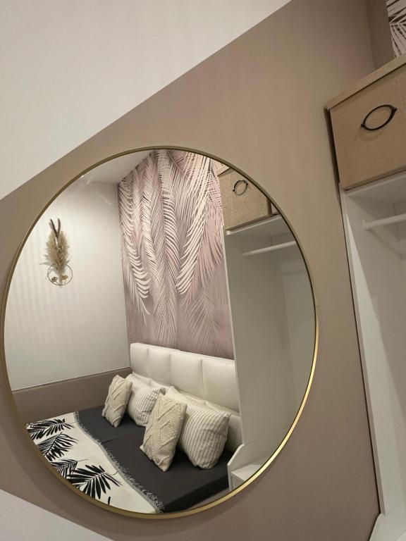 a mirror in a room with a shelf and pillows at Ferienwohnung Lauri Sommeraktion 2025 in Bayreuth