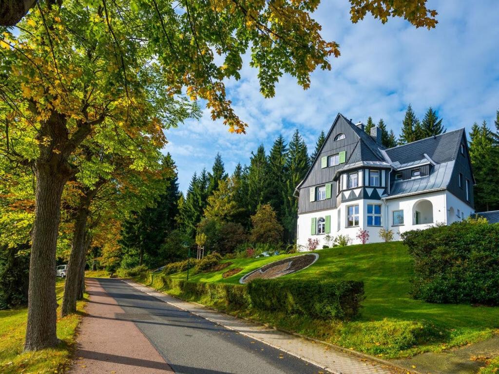 a large house on a hill with a road at Holiday apartment Waldfrieden in Kurort Bärenburg