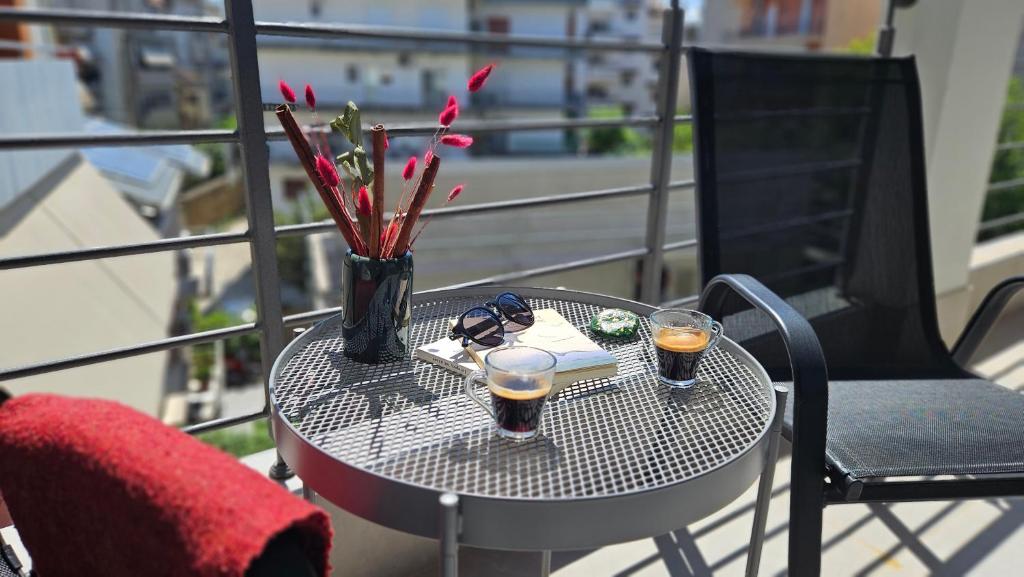 una mesa en un balcón con 2 copas de cerveza en Sezame ApartHotel, en Ioannina