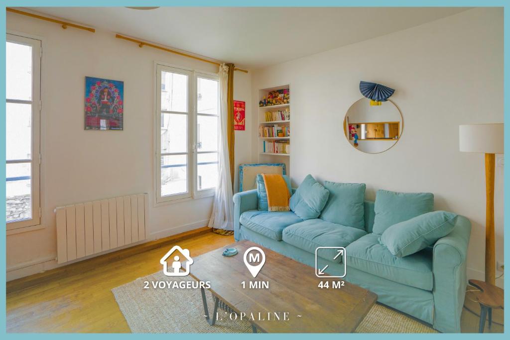 a living room with a blue couch in a room at L'Opaline ~ T2 Calme ~ Proche Métro Idéal pour JO in Paris