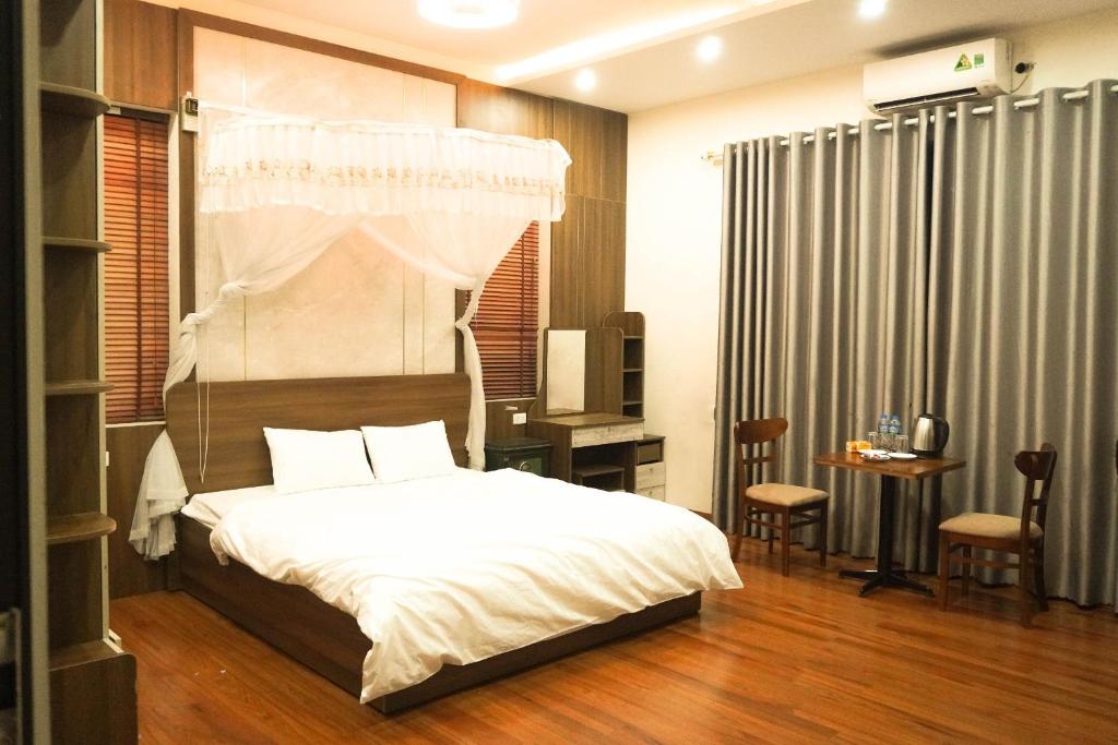 ein Schlafzimmer mit einem Himmelbett in der Unterkunft A Thía homestay in Diện Biên Phủ