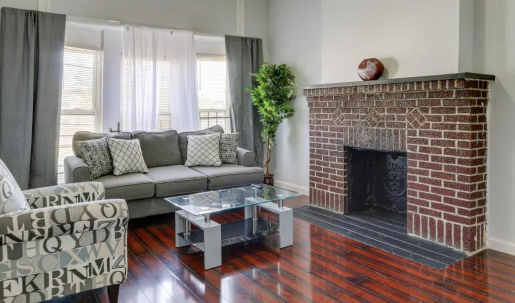 a living room with a couch and a fireplace at Cozy bedroom 6 minutes from Newark Liberty International Airport Rm C in Newark