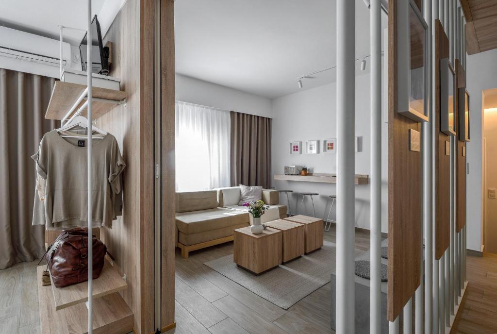 a living room with a couch and a table at Heritage & Tales: Sihna in Litochoro