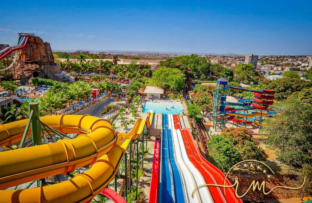 an amusement park with a pool and a roller coaster at Spazzio diRoma RM Hospedagem com Acesso Acqua Park/Splash in Caldas Novas